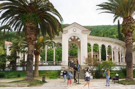 Gagra, Abkhazia - may 02, 2019: People descend the steps of the colonnade in the seaside Park. Weekend on a warm spring dayのeditorial素材