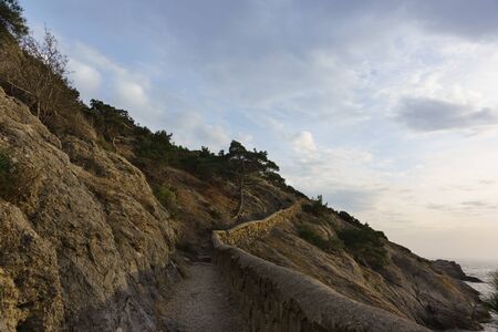 Golitsyn trail on Cape Kapchik on a cloudy evening in early spring. Twilightの写真素材