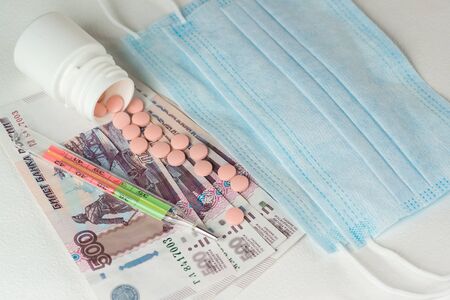 The tablets were scattered on Russian ruble banknotes, a medical thermometer, and disposable masks....