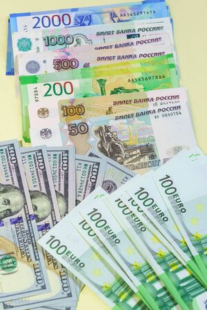 Background of banknotes from different countries spread out on the table: Russian rubles, us dollars...