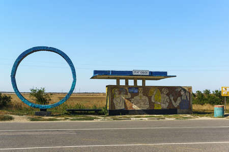 Lugovoye, Crimea, Russia, September 13, 2019: An old Soviet-era bus stop on a road in Crimea. The...