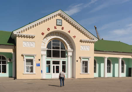 Russia, Crimea, Feodosia September 18, 2020 - The building with the clock of the railway station on Gorky Street, house 1. Russian text: Railway stationのeditorial素材