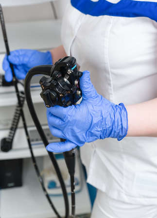 Medical equipment for video esophagogastroduodenoscopy in the hands of blue gloves. Conducting the...