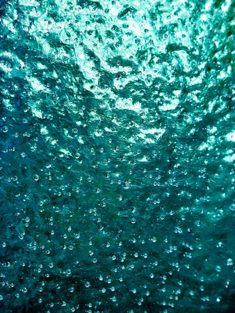 Greenish cian cold ice vertical brilliant background reflecting lightの写真素材