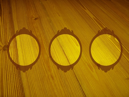 Warm circular frames in yellow old wood backdropの写真素材