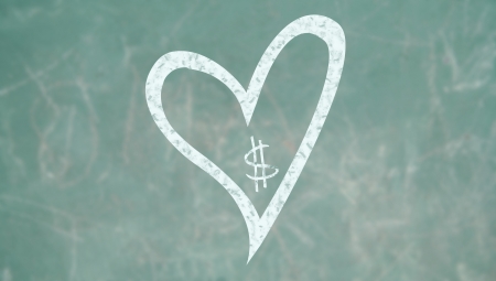 Priority to love over money concept on a class school blackboardの写真素材
