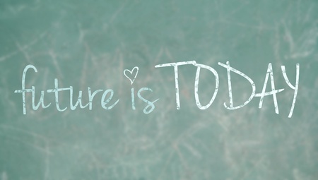 Future is today over a green school blackboardの写真素材