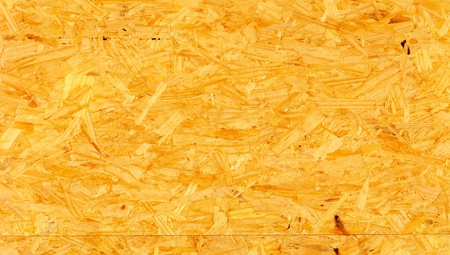 Agglomerate panel of wood pieces as yellow fiber background