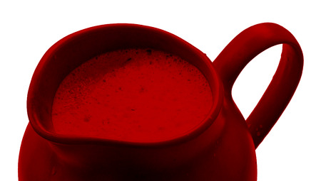 Dark red drink in rounded jar close up isolated on whiteの写真素材