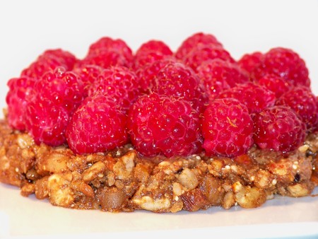 Raspberries tart dessert mini cake with seeds and nuts raw baseの写真素材