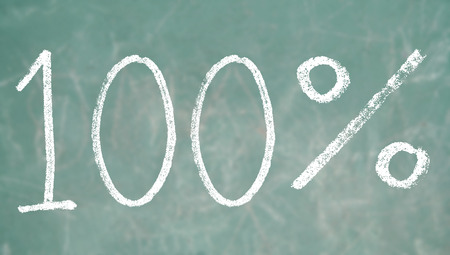 One hundred percentage symbol on a class blackboardの写真素材
