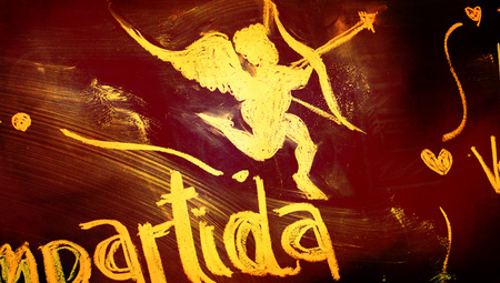 Gold Cupid angel draw of chalk on old chalkboard grunge background