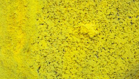 Yellow abstract textured background of painted wallの写真素材