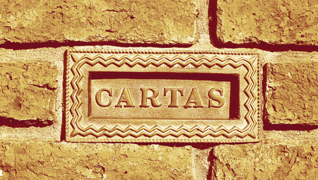 Mail box with cartas spanish word on wall background of bricksの写真素材