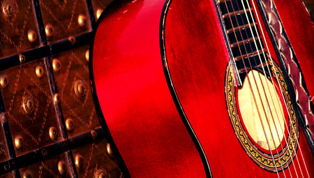 Red acoustic guitar close up