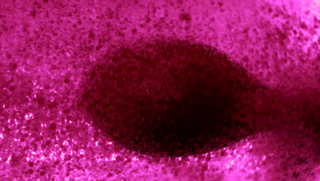 Dark drop in pink water drops backgroundの写真素材