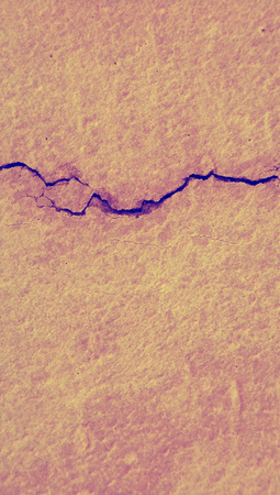 Purple crack on pink wall abstract vertical background