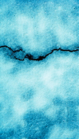 Blue crack on vertical wall background