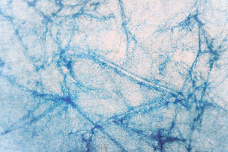 Artisanal blue cracked paper background of recycled materials