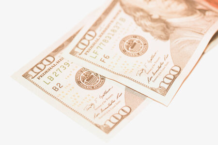 Two hundred dollars bills in sepia on white