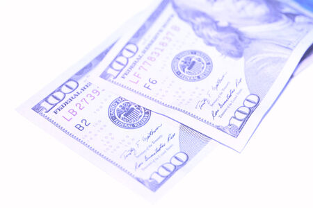 Blue dollars bills couple isolated on white backgroundの写真素材