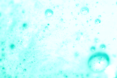 Soap foam close up in light blue abstract clean 