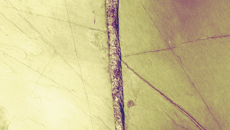 Iron nail line in the middle of a wall macro abstract background