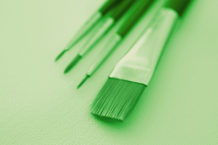 Brushes for painting tools close up in green color stock imageの写真素材