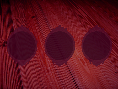 Dark wood background with three circular framesの写真素材