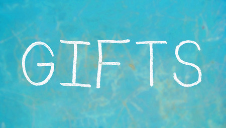 Gifts caps word of chalk on blue