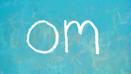 Om chalk mantra written on blueの写真素材