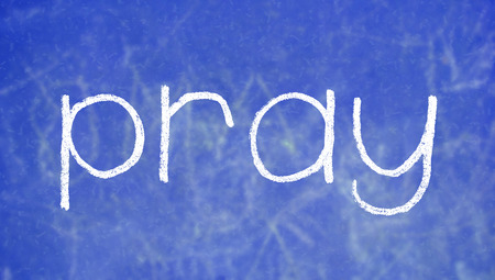Pray chalk word on blue boardの写真素材