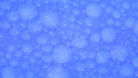 Blue soap water textured background close up