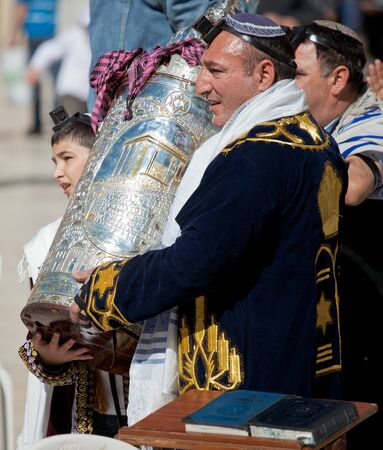 JERUSALEM, ISRAEL - Feb 18, 2013: Bar Mitzvah ritual at the Wailing wall in Jerusalem. A 13 years old boy who has become Bar Mitzvah is morally and ethically responsible for his decisions and actionsのeditorial素材