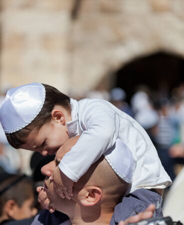 JERUSALEM, ISRAEL - Feb 18, 2013: Bar Mitzvah ritual at the Wailing wall in Jerusalem. A 13 years old boy who has become Bar Mitzvah is morally and ethically responsible for his decisions and actionsのeditorial素材