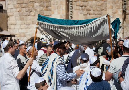 JERUSALEM, ISRAEL - Feb 18, 2013: Bar Mitzvah ritual at the Wailing wall in Jerusalem. A 13 years old boy who has become Bar Mitzvah is morally and ethically responsible for his decisions and actionsのeditorial素材