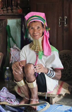 Myanmar, Burma - December 30, 2013: Smiling long-neck Kayan Padaung woman in Myanmar, Burma. Beautiful portrait of woman with neck rings brass coils calling giraffe womenのeditorial素材