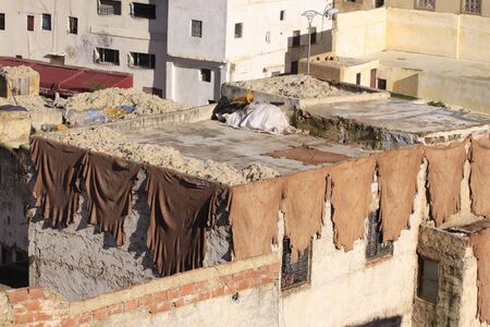 Fez, Morocco - January 01, 2010: Workers are dyeing and tanning leather at the tannery in Fez using the traditional method with pigeon dung and salt. Fes el Bali, Morocco, Africa.のeditorial素材