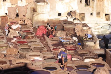 Fez, Morocco - January 01, 2010: Workers are dyeing and tanning leather at the tannery in Fez using the traditional method with pigeon dung and salt. Fes el Bali, Morocco, Africa.のeditorial素材