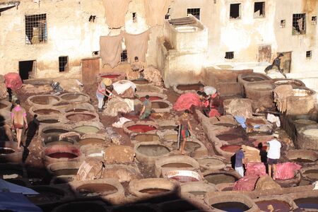 Fez, Morocco - January 01, 2010: Workers are dyeing and tanning leather at the tannery in Fez using the traditional method with pigeon dung and salt. Fes el Bali, Morocco, Africaのeditorial素材
