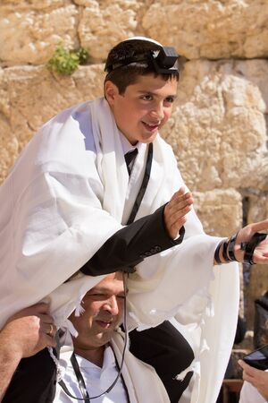 JERUSALEM, ISRAEL - Feb 18, 2013: Bar Mitzvah ritual at the Wailing wall in Jerusalem. A 13 years old boy who has become Bar Mitzvah is morally and ethically responsible for his decisions and actionsのeditorial素材