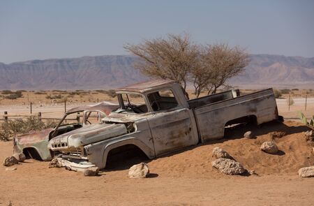 Abandoned old wrecked historic cars near a service station at Solitaire in Namibia desert ear the Namib-Naukluft National Parkの写真素材