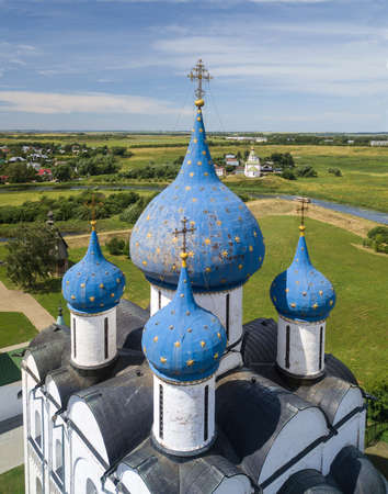 The ancient town of Suzdal. Aerial view on the blue domes with stars of the Kremlin. Gold ring of...