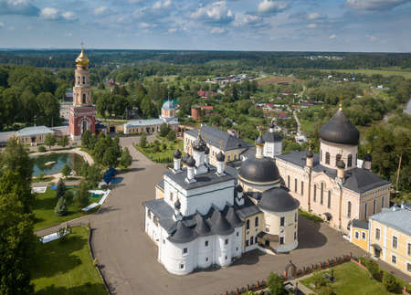 Aerial summer view of white old monastery with golden domes in Russia.