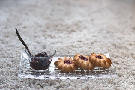 Biscuits on the glass plate with jam.