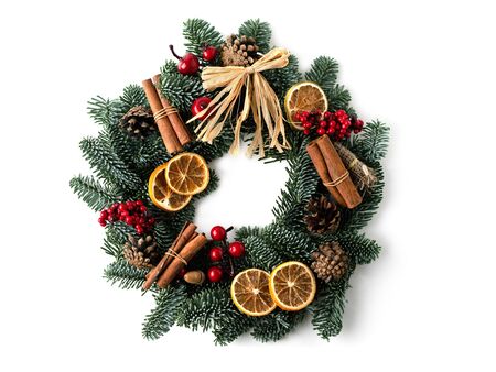 A traditional green christmas wreath isolated with dry orange slice, cinnamon sticks as a decoration.の写真素材