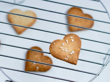 Just baked homemade heart shape cookies with a selective focus.の写真素材