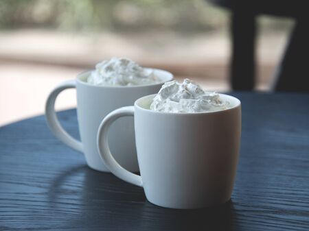 Two white mug of matcha latte with selective focus - Freshly brewed drink - cafe, window and coffee shopの写真素材