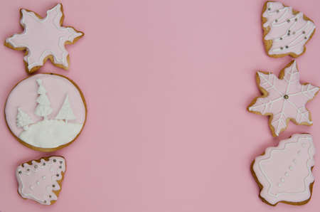 Frame made from cookies. Christmas frame of iced gingerbread cookies on a pink background. Home made. Food backgrund.の写真素材