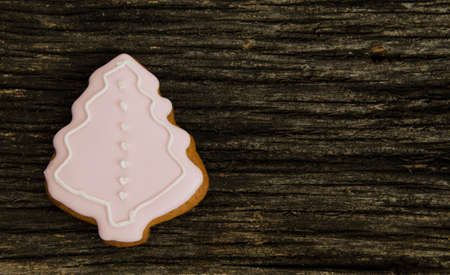 Christmas tree iced gingerbread cookies on a old textured wood background. Home made. Food backgrund.の写真素材